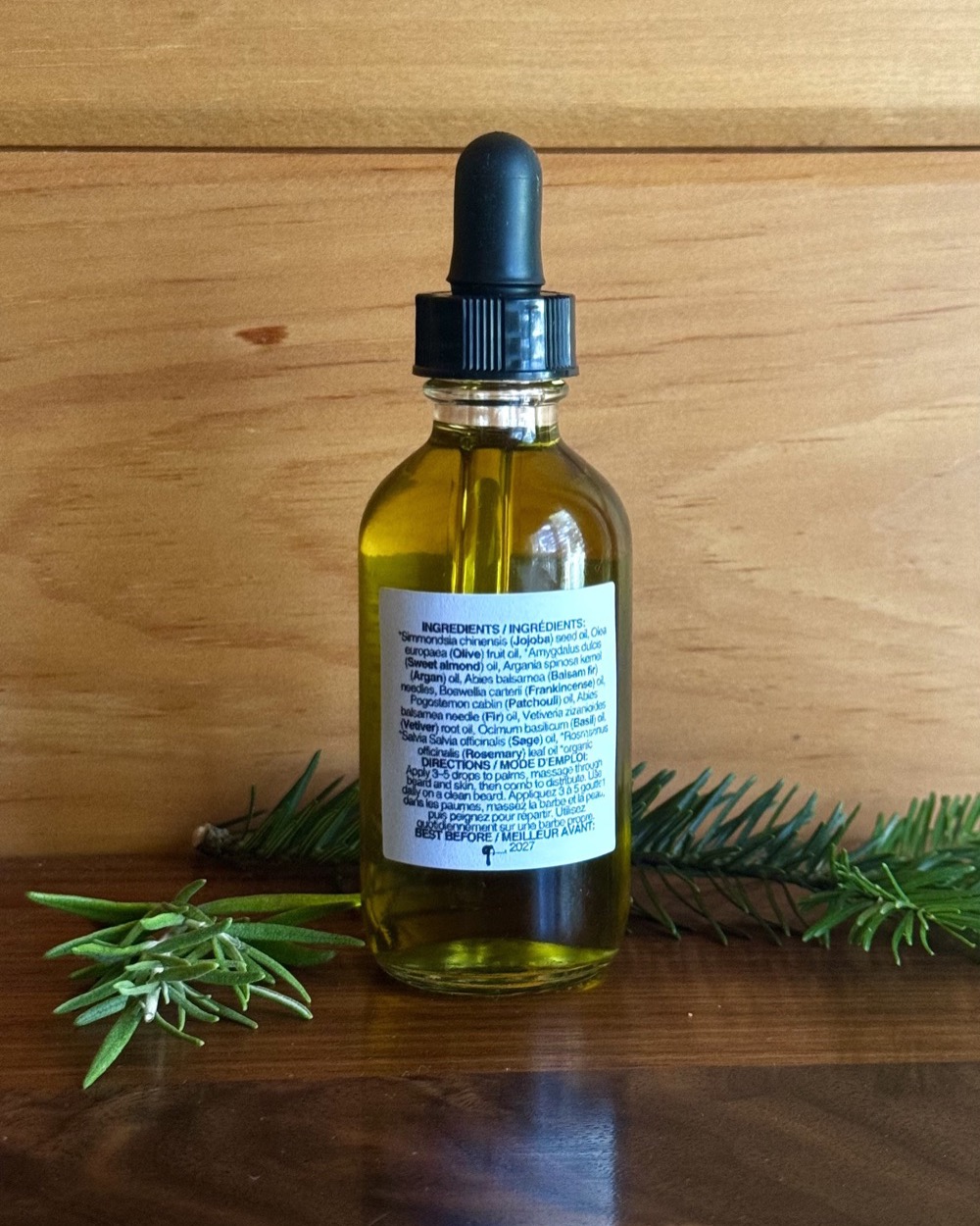 Back label listing the jojoba, olive, sweet almond and argan base and the balsam fir, frankincense and vetiver essential oils