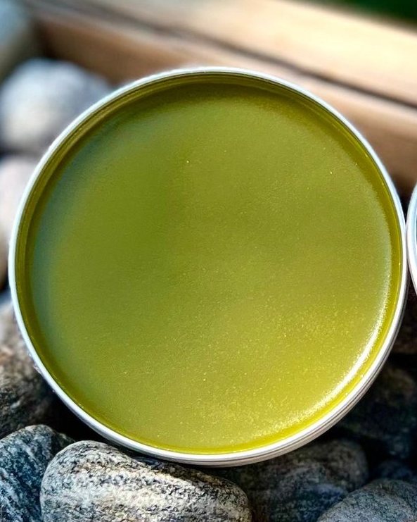 Open tin of green comfrey rescue salve